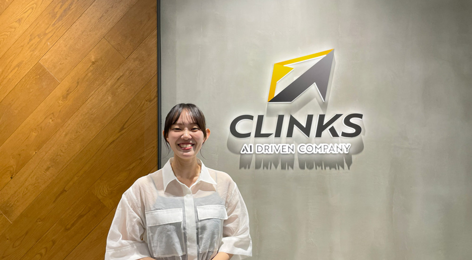 CLINKSのロゴ前の久野さん